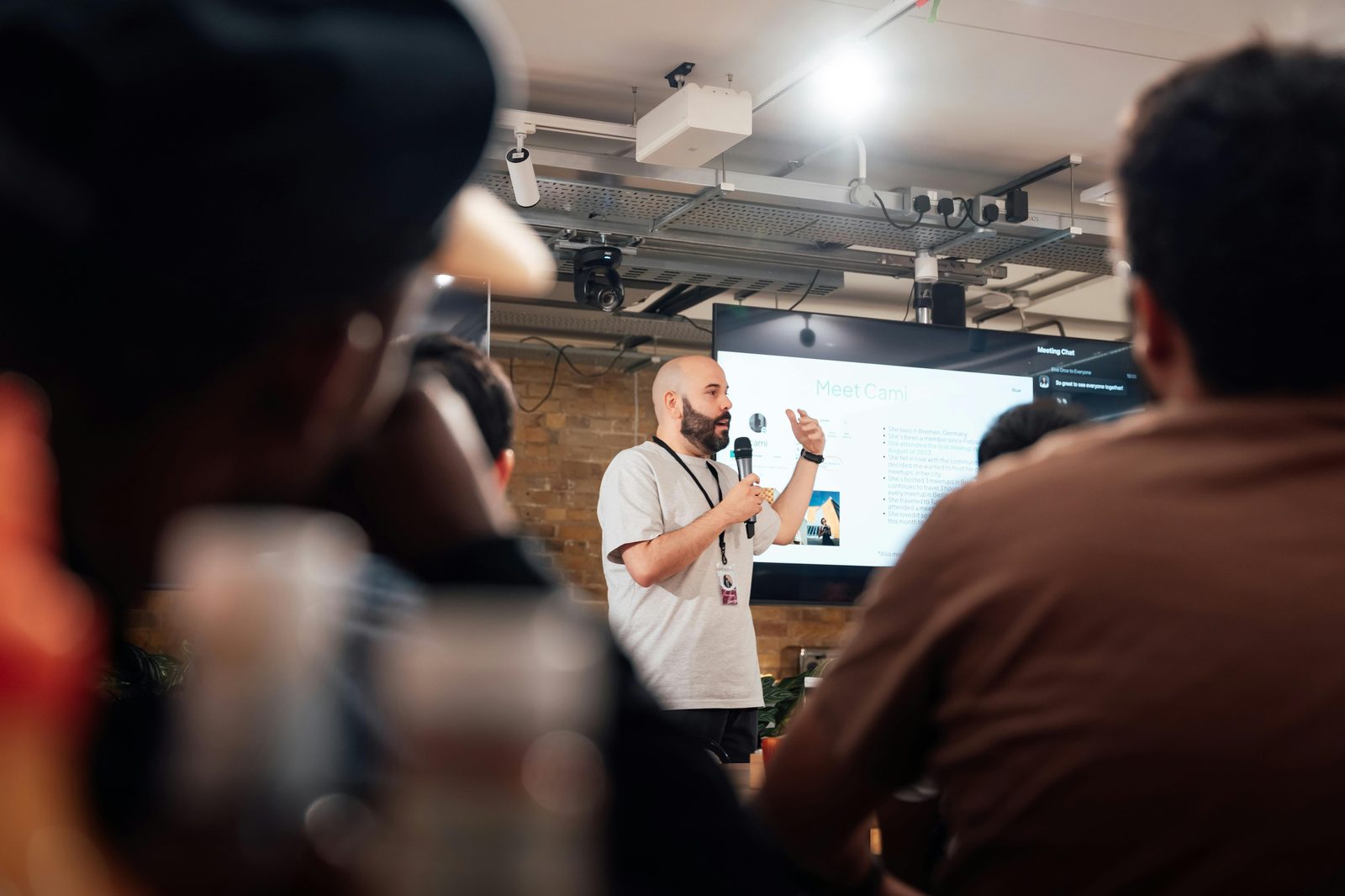 Speaker presenting at a tech event in Boston with audience engaged