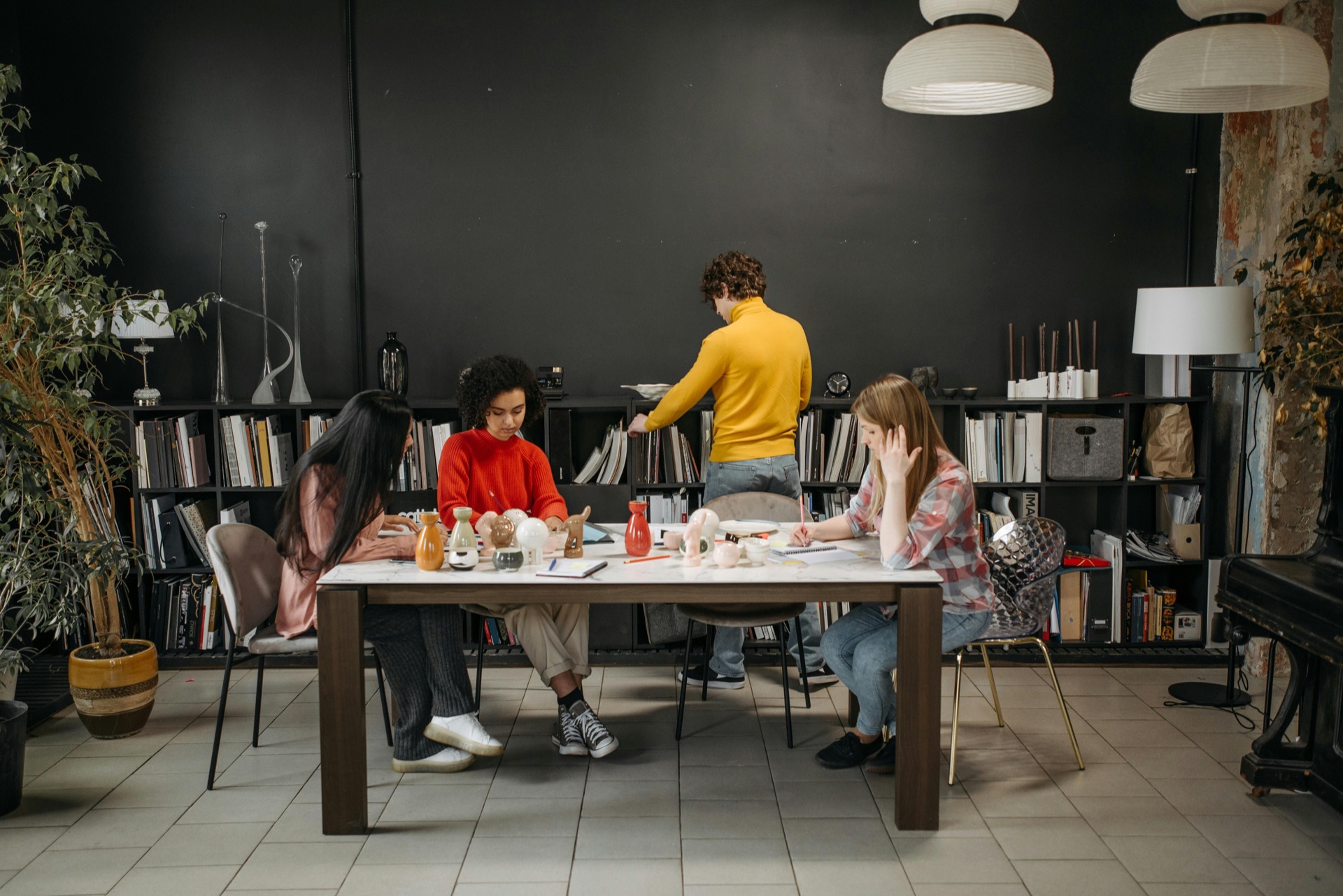 Remote worker isolated at home while colleagues collaborate in an office