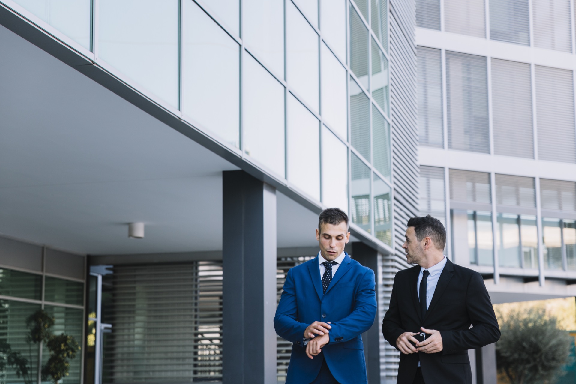 Two corporate managers discussing workspace strategy