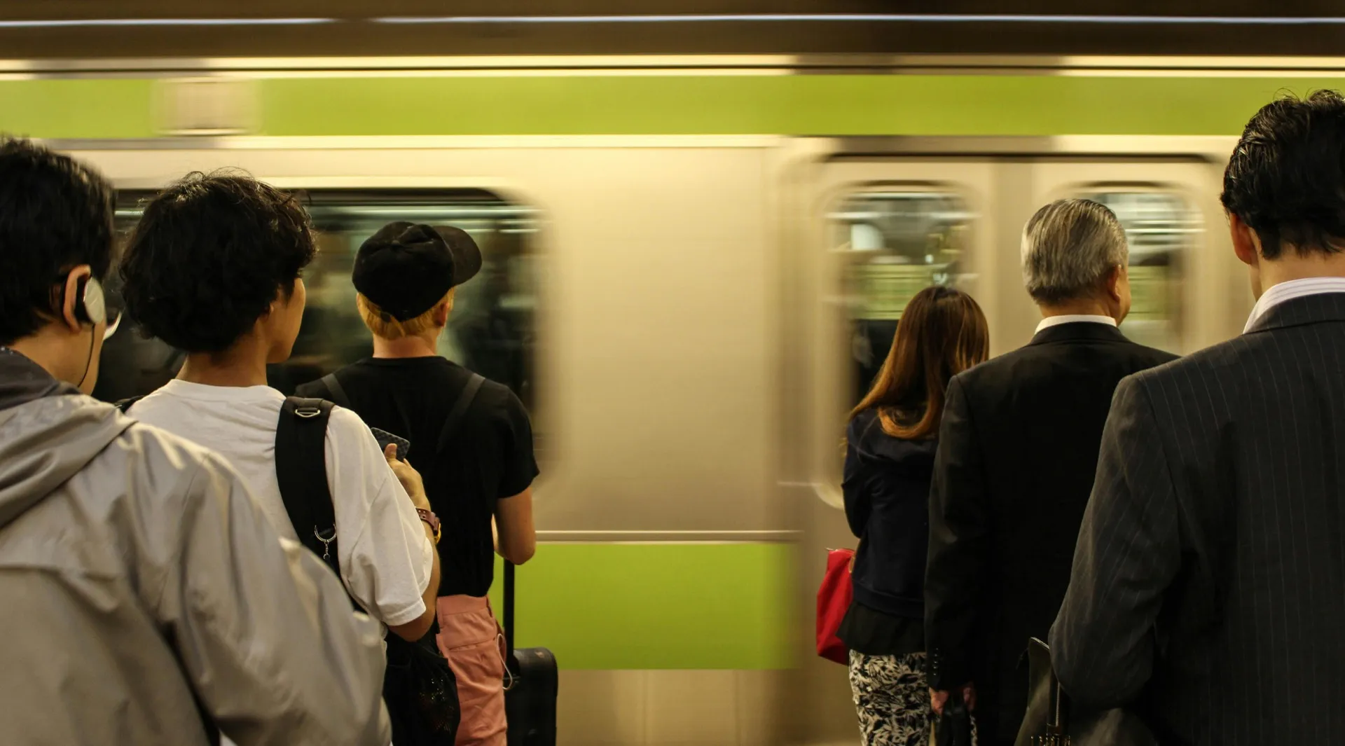 Crowded subway platform during morning rush hour, representing the daily cost employees absorb with RTO mandates