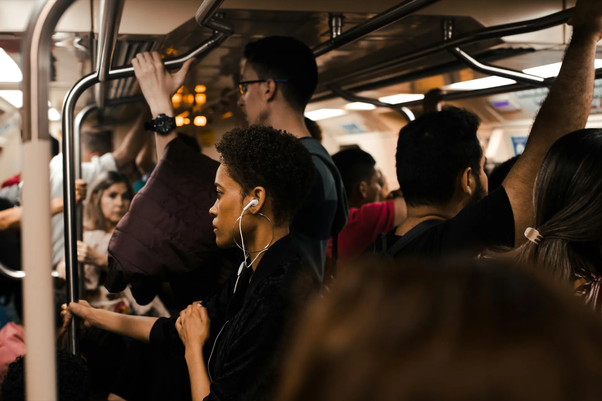 Packed subway car during peak commute, representing the daily cost employees weigh against office value