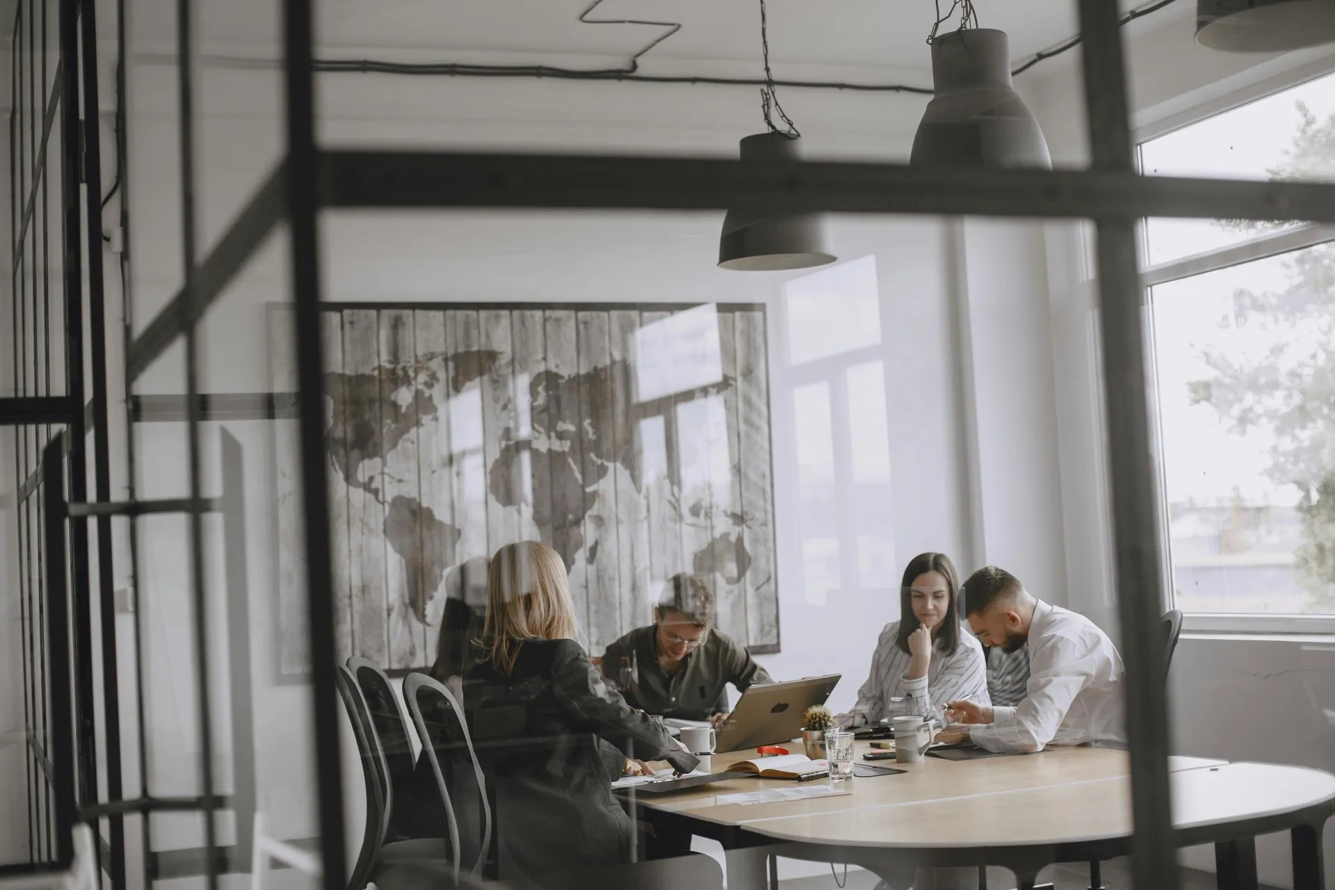 Team members gathered around a table for a strategy meeting in a professional workspace