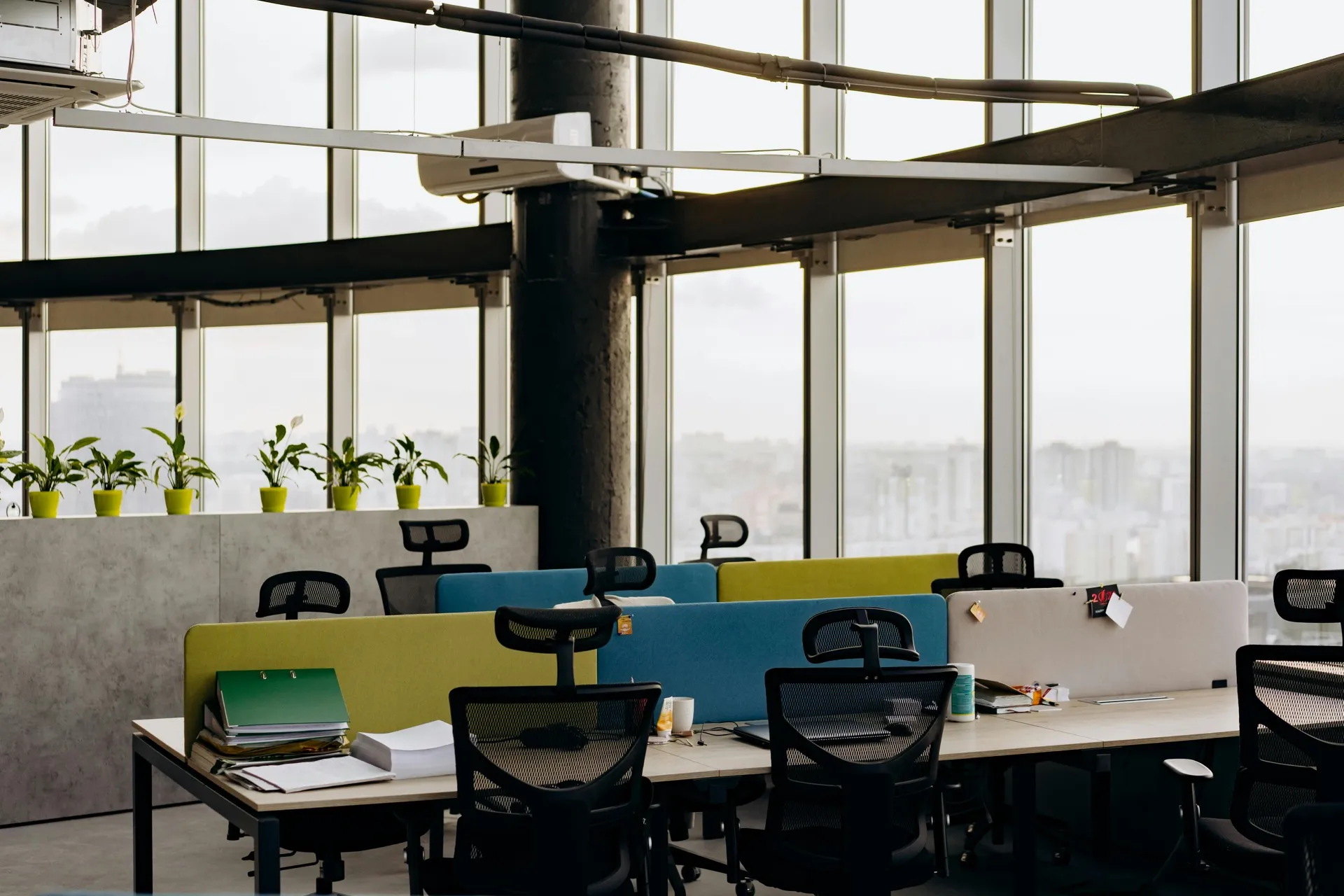 Empty desks in an office with nobody working at them