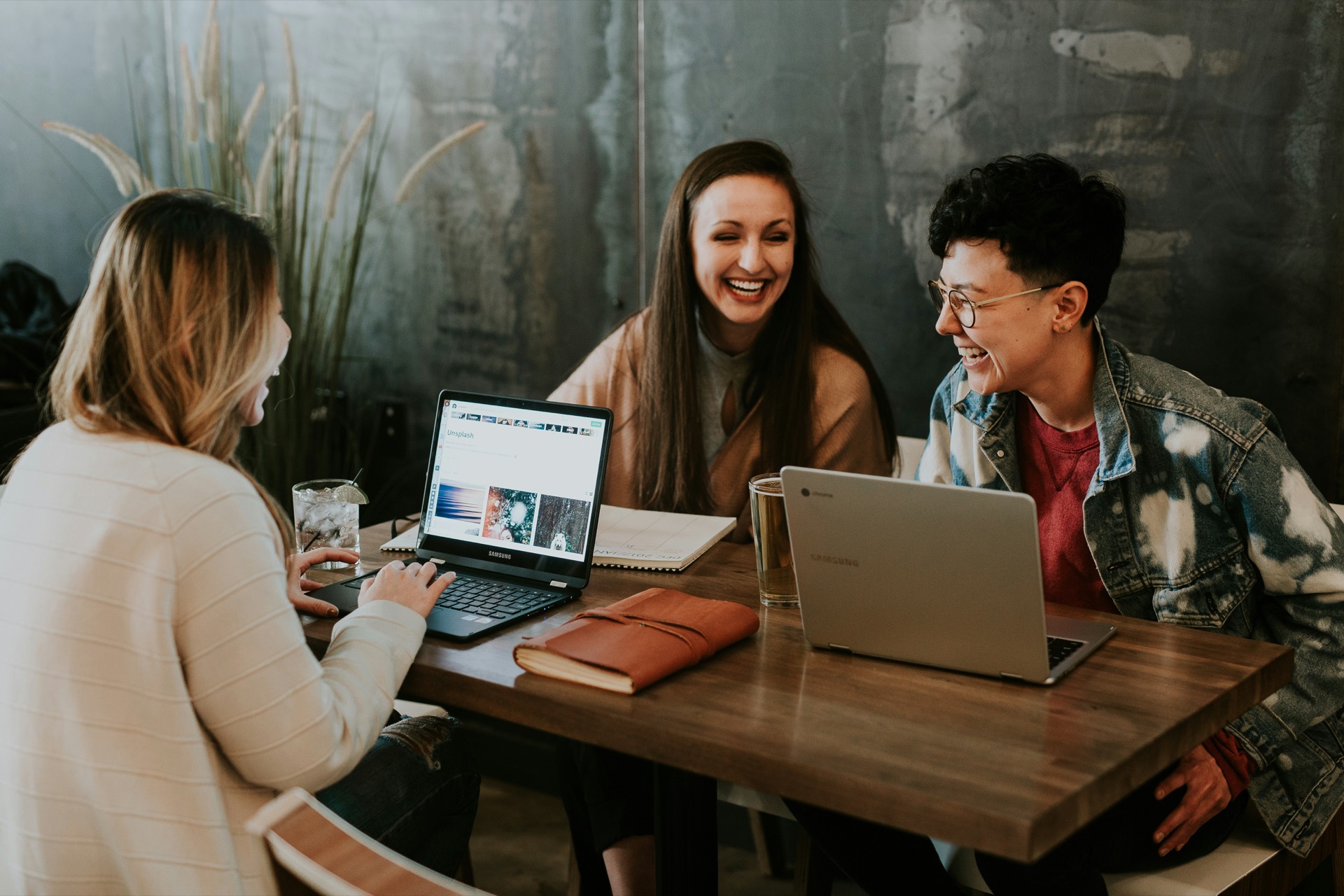 Friends collaborating in a coworking cafe space