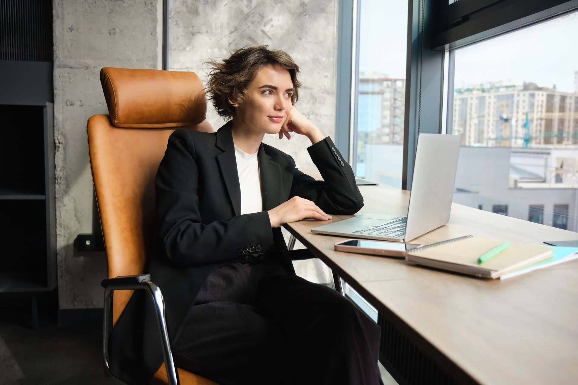Office manager coordinating a hybrid team in a modern flexible workspace