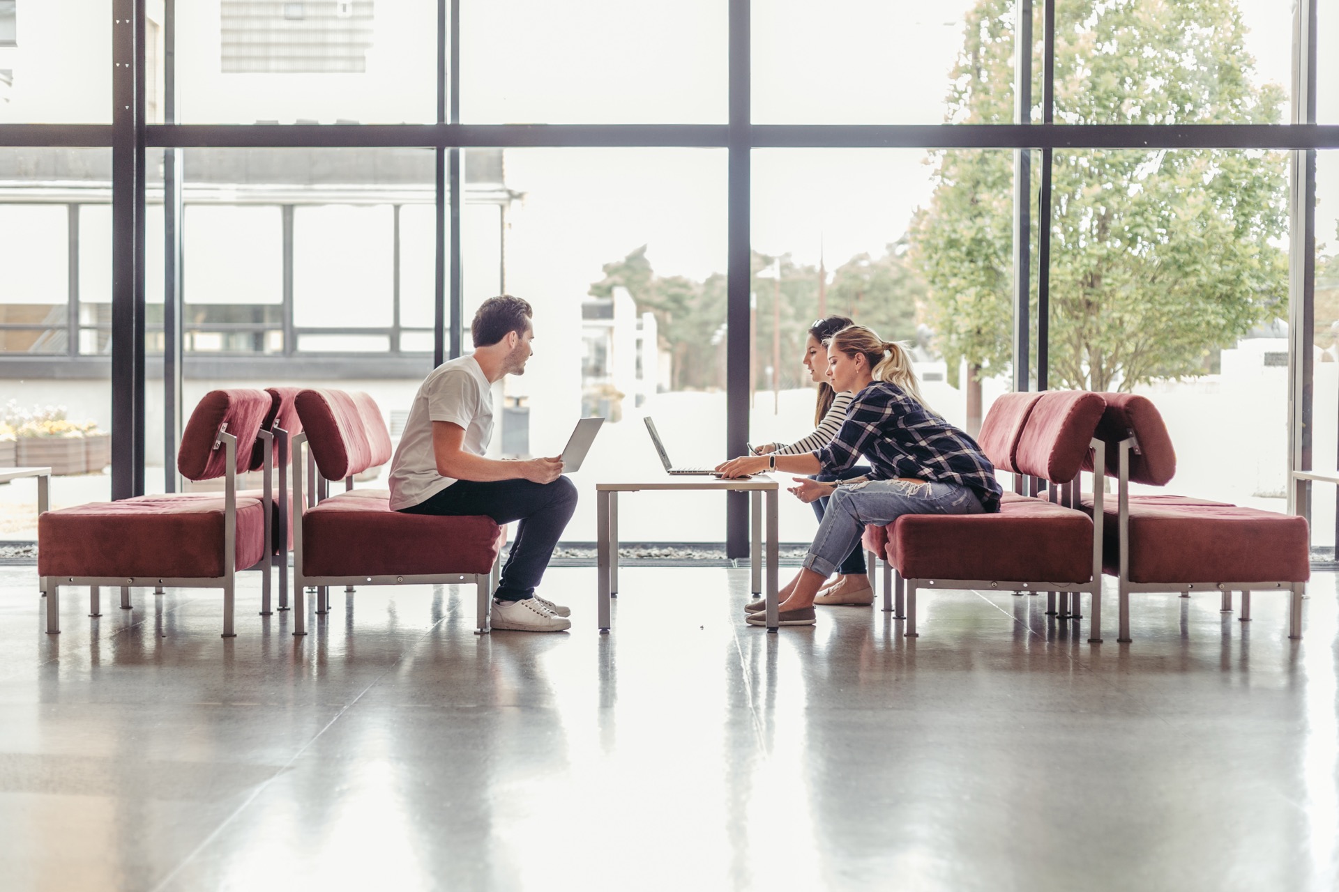 People working on laptops in a modern coworking space